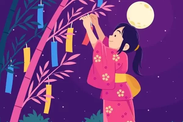 Une fille accroche un vœu à un bambou